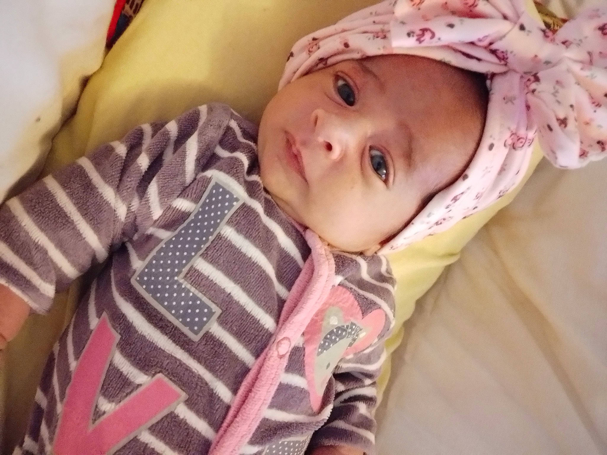 Leila participe au concours pour gagner de l'argent avec cette photo : baby, baby_toddler_clothing, cheek, child, comfort, eye, eyelash, fashion_accessory, fun, happy, headwear, iris, linens, lip, magenta, nose, outerwear, person, pink, skin