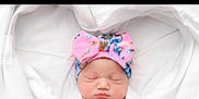 Callie Wynter joined the competition — help win amazing prizes! newborn, baby, sleeping, headband, pink, blue, floral, blanket, white, infant, cute, peaceful, wrapped, soft, hands, face, portrait, cozy, child, resting