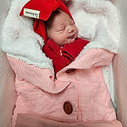 Callie Wynter joined the competition — help win amazing prizes! newborn, baby, sleeping, red_hat, red_outfit, pink_blanket, knitted_blanket, cozy, soft_texture, cushion, indoor, infant, peaceful, cute, portrait, wrapped, child, warm, resting, smiling