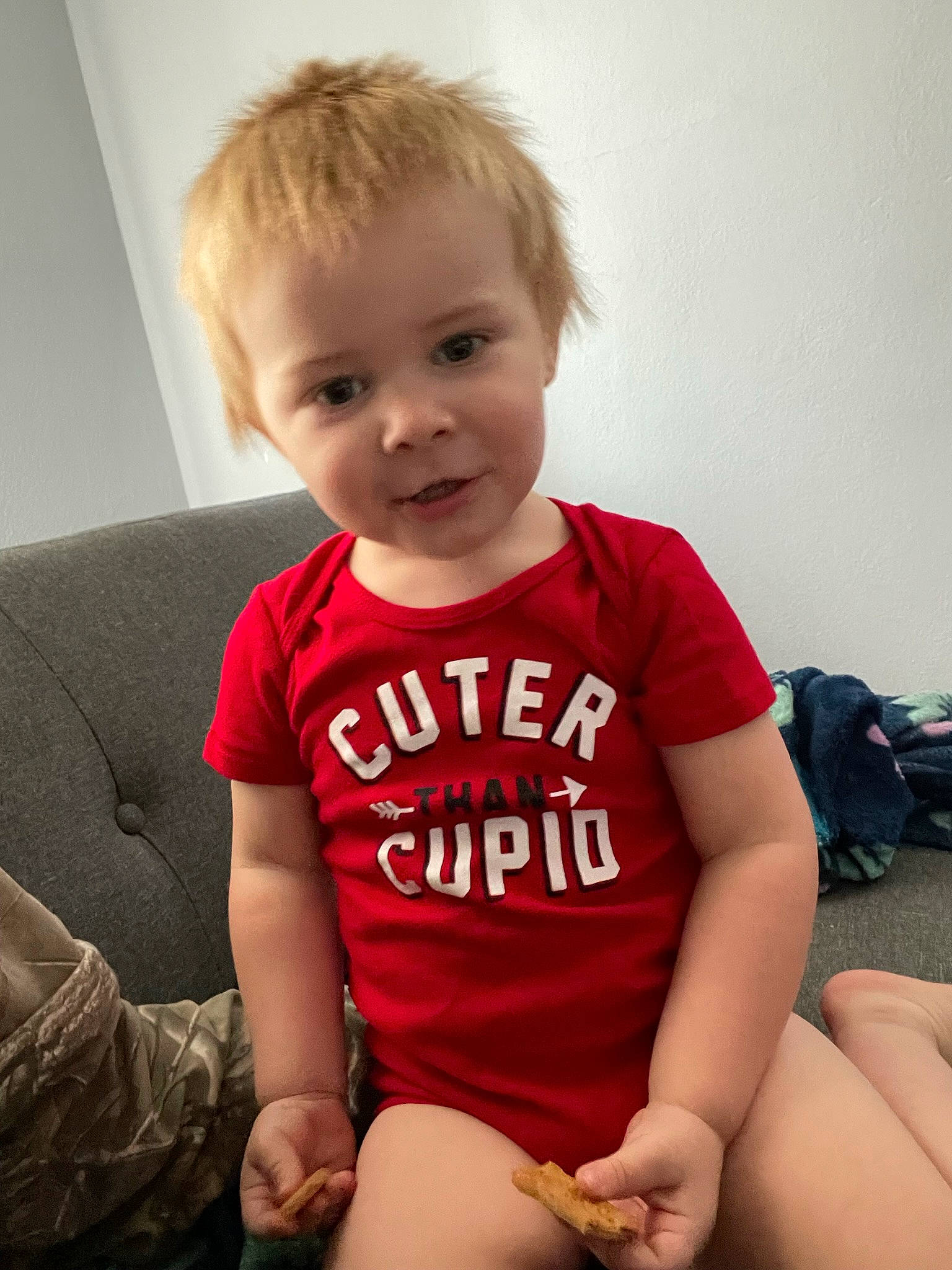 Paxton is registered to the contest to win money with this photo: arm, baby_toddler_clothing, beauty, cheek, child, comfort, elbow, facial_expression, happy, human_leg, joint, knee, luggage_and_bags, person, skin, sleeve, smile, standing, t_shirt, thigh