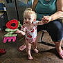 Daenerys Rhaenerya joined the competition — help win amazing prizes! toddler, child, adult, holding_hands, strawberry_outfit, one_sign, curly_hair, indoor, kitchen, flooring, flip_flops, smiling, celebration, person, baby, standing, wood_floor, refrigerator, casual_clothing, family