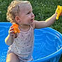 Daenerys joined the competition — help win amazing prizes! toddler, child, curly_hair, blue_pool, toy, outdoor, grass, smiling, summer, sunlight, sleeveless_shirt, play, happy, cute, earrings, plastic, nature, fun, small_child, playtime