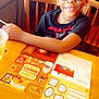 Ezekiel is registered to the contest to win money with this photo: child, boy, smiling, glasses, restaurant, wooden_table, wooden_chair, activity_sheet, drink_cup, straw, t_shirt, star_wars_shirt, indoor, happy, portrait, face, table_setting, kids_activity, paper_menu, casual_dining