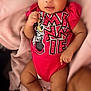 baby, infant, pink_headband, bow, red_onesie, minnie_mouse, blanket, fluffy_booties, cute, child, portrait, indoor, cozy, soft_texture, smiling, looking_at_camera, skin, hand, legs, clothing