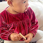 Heavenly joined the competition — help win amazing prizes! toddler, child, red_velvet, headband, sitting, holding, biscuit, white_leggings, cushion, indoor, curious, portrait, baby, soft_lighting, closeup, cute, face, small_hands, furniture, cozy