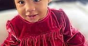 Heavenly is registered to the contest to win money with this photo: baby, blanket, bow, candid, child, cozy, cracker, cute, eyes, face, hand, headband, indoor, portrait, red_dress, sitting, smile, snack, toddler, velvet