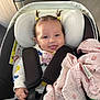 Maïzy a rejoint le concours — aidez-le/la à gagner de superbes lots ! baby, child, car_seat, hair_ties, pacifier, blanket, smiling, happy, infant, clothing, seatbelt, indoor, cute, toddler, face, person, childcare, safety, comfort, head_support