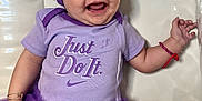 Maïzy a rejoint le concours — aidez-le/la à gagner de superbes lots ! baby, child, smile, purple, tutu, headband, bow, clothing, onesie, bracelet, happy, cute, infant, face, person, apparel, fashion, joyful, sitting, portrait