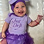 baby, child, smile, purple, tutu, headband, bow, clothing, onesie, bracelet, happy, cute, infant, face, person, apparel, fashion, joyful, sitting, portrait
