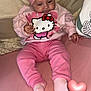 Maïzy participe au concours pour gagner de l'argent avec cette photo : baby, pink, headband, bow, hello_kitty, sweater, socks, couch, pillow, soft_toys, child, indoor, cute, portrait, infant, clothing, smiling, relaxed, seated, heart_emoji