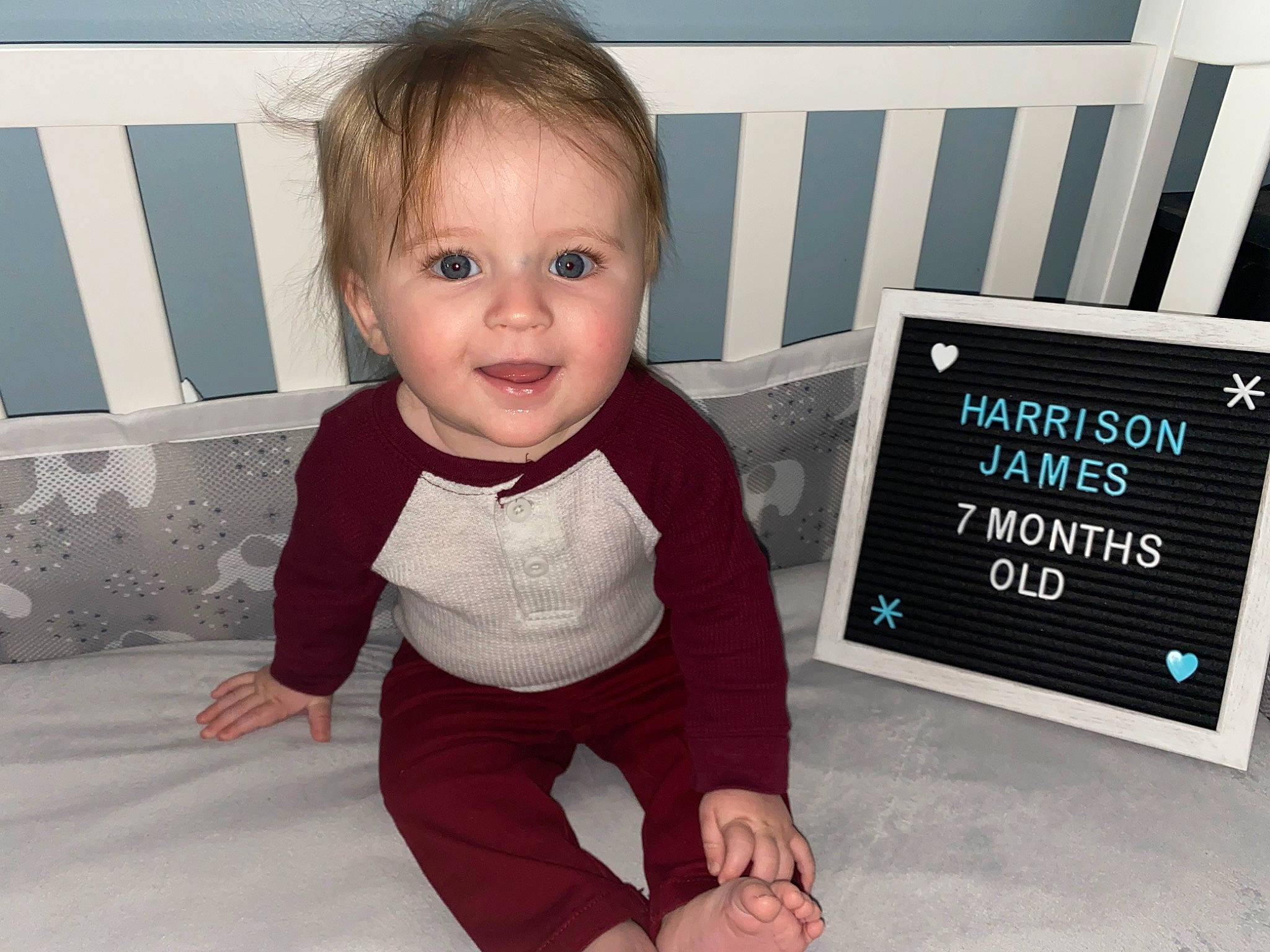 Harrison is registered to the contest to win money with this photo: baby, baby_toddler_clothing, child, comfort, electric_blue, flooring, fun, happy, joy, mammal, pattern, people, person, product, rectangle, room, sitting, sleeve, smile, standing