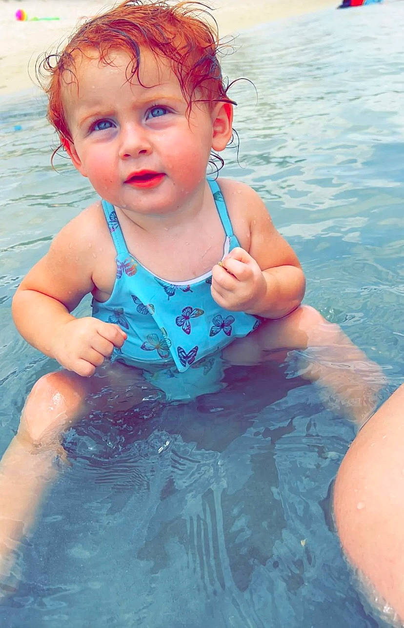 Paisleigh joined the competition — help win amazing prizes! arm, baby, bathing, blue, chest, child, face, fun, games, hand, happy, human_body, leisure, outdoor_recreation, person, personal_protective_equipment, recreation, swimming_pool, swimwear, toddler