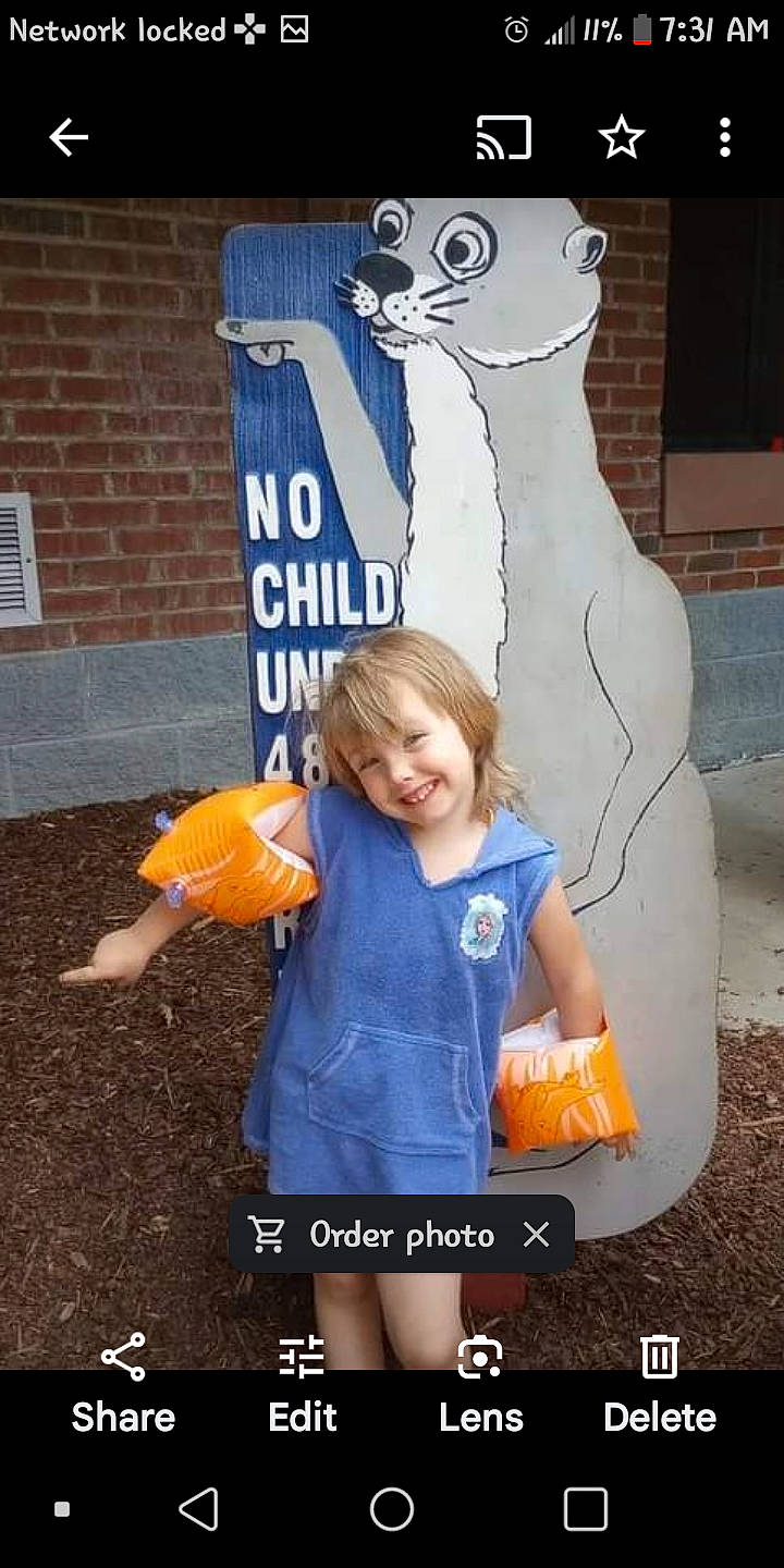 Presley is registered to the contest to win money with this photo: advertising, art, brick, brickwork, child, electric_blue, fun, gesture, happy, joy, northern_seahorse, orange, person, photograph, recreation, signage, sleeve, standing, syngnathiformes, t_shirt