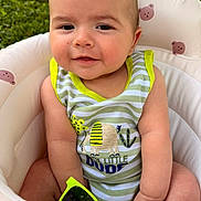 Elijah is registered to the contest to win money with this photo: baby, bear_pattern, casual, child, cushion, cute, face, green_background, happy, infant, outdoor, person, playful, portrait, seat, smile, striped_clothing, summer, sunglasses, sunny