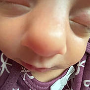 Delilah joined the competition — help win amazing prizes! baby, close_up, face, sleeping, nose, eyes_closed, purple_clothing, bow, infant, skin, soft, young_child, cute, portrait, child, apparel, fabric, pattern, toddler, peaceful