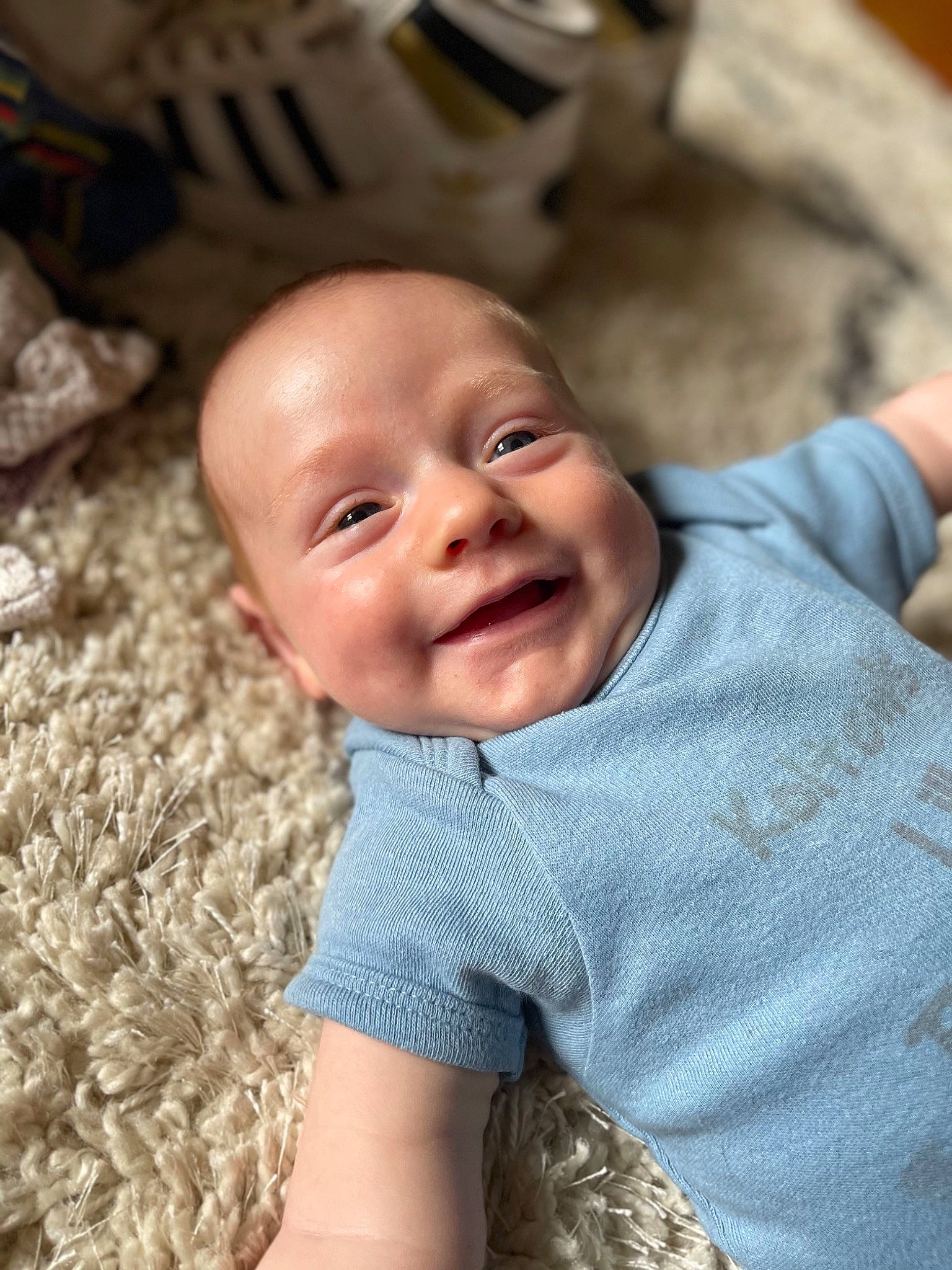 Ryker joined the competition — help win amazing prizes! baby, baby_toddler_clothing, cheek, child, eye, finger, fun, grass, happy, head, iris, joy, laugh, nose, people_in_nature, person, sitting, skin, sleeve, smile