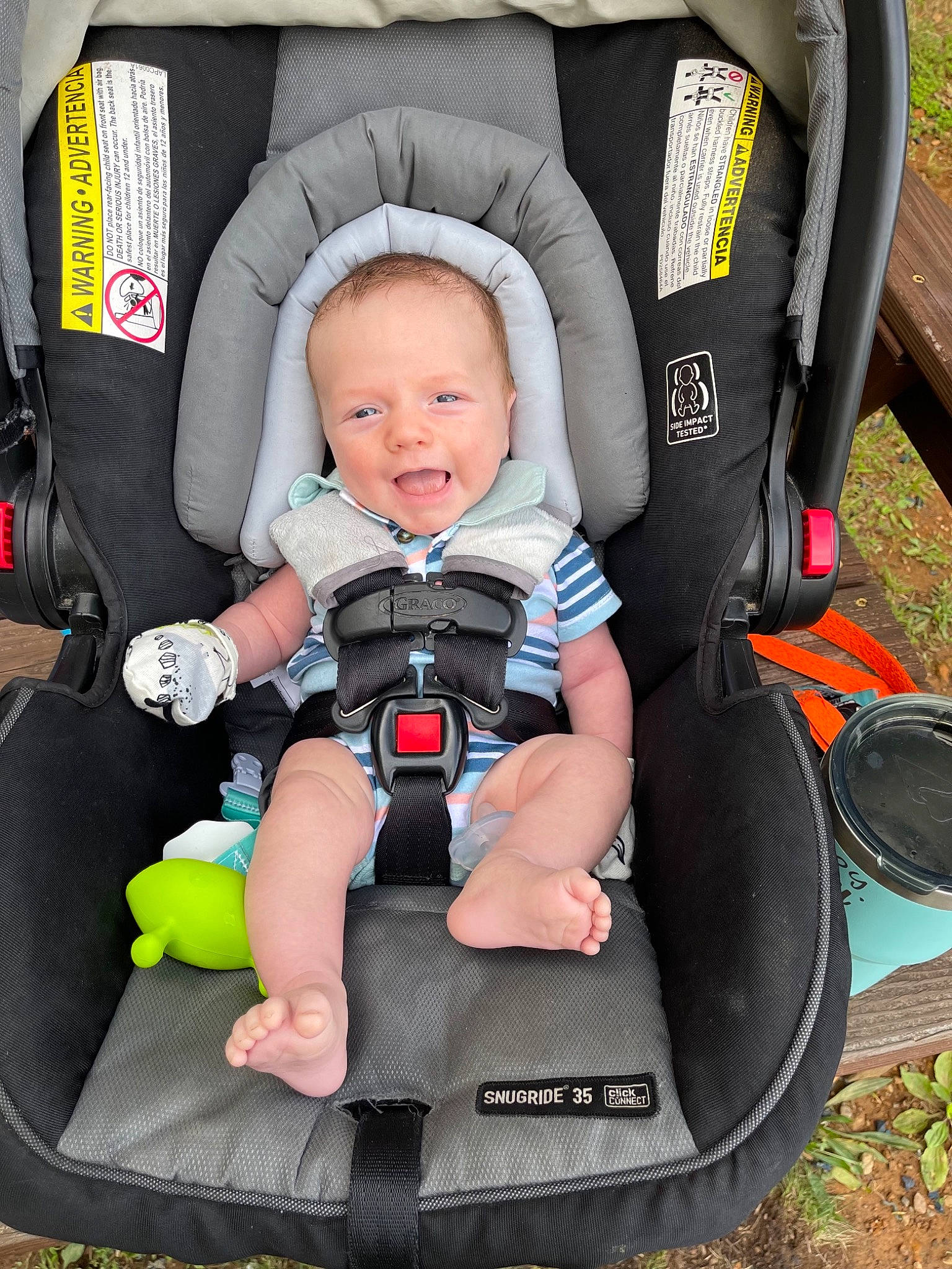 Ryker joined the competition — help win amazing prizes! auto_part, baby, baby_carriage, baby_products, baby_toddler_clothing, black, blue, car_seat, chair, child, comfort, fun, grass, green, person, photograph, sitting, toddler, vacation, wheel