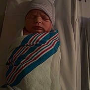 Denver joined the competition — help win amazing prizes! newborn, baby, swaddled, hospital_bed, blanket, hat, sleeping, infant, portrait, child, peaceful, wrapped, indoors, healthcare, person, resting, cute, soft_lighting, newborn_baby, toddler