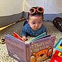 Hady joined the competition — help win amazing prizes! baby, child, reading, book, sunglasses, orange, blue_clothing, rug, tent, indoor, toy, floor, curious, face, headwear, colorful, children, play, literature, cozy