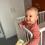 Gabriëlla participe au concours pour gagner de l'argent avec cette photo : baby, bedroom, child, clothing, crib, curious, cute, face, furniture, hand, home, indoors, person, pigtails, playful, smiling, stuffed_animal, toddler, toy, young_child