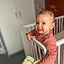 baby, bedroom, child, clothing, crib, curious, cute, face, furniture, hand, home, indoors, person, pigtails, playful, smiling, stuffed_animal, toddler, toy, young_child