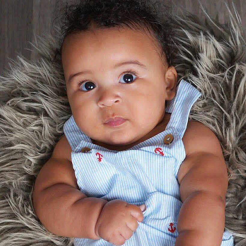 Duke joined the competition — help win amazing prizes! baby, infant, child, face, eyes, skin, arm, clothing, blue, striped, anchor, cute, fluffy, rug, portrait, expression, closeup, newborn, chubby, indoors