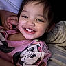 baby, cartoon_character, child, closeup, clothing, cozy, cute, expression, face, hair, hand, happy, indoor, minnie_mouse, person, pink_shirt, portrait, skin, smile, toddler