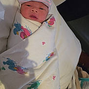 Zayn is registered to the contest to win money with this photo: newborn, baby, infant, hospital, blanket, bed, swaddled, hat, medical_equipment, patient, person, indoors, resting, cute, sleeping, portrait, hospital_bed, child, healthcare, cozy