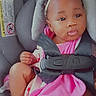 baby, child, car_seat, seatbelt, pink_clothing, headband, bow, infant, cute, safety, child_seat, portrait, indoors, baby_girl, skin, face, legs, feet, expression, young_child