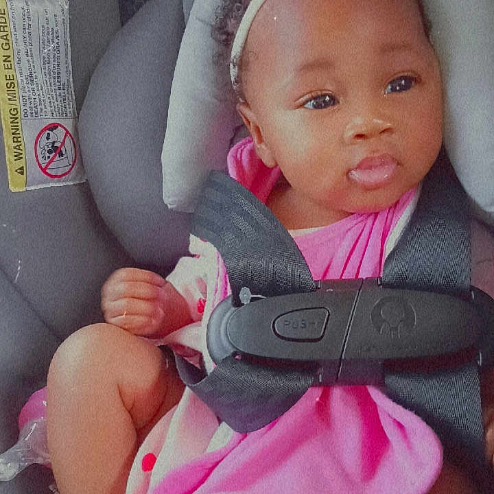 Serenity joined the competition — help win amazing prizes! baby, child, car_seat, seatbelt, pink_clothing, headband, bow, infant, cute, safety, child_seat, portrait, indoors, baby_girl, skin, face, legs, feet, expression, young_child