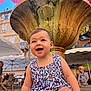 Diane participe au concours pour gagner de l'argent avec cette photo : toddler, child, smiling, fountain, outdoor, umbrella, water, play, people, summer, happy, blue_sky, building, clothing, public_space, daytime, fun, cute, expression, holiday