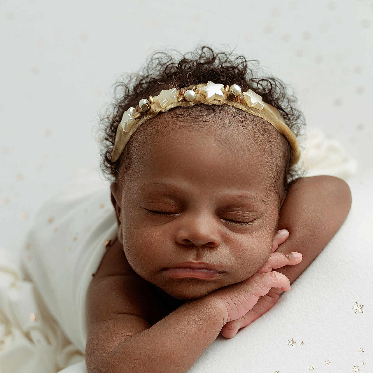 Tchani is registered to the contest to win money with this photo: baby, sleeping, headband, star, curly_hair, arm, blanket, soft_texture, peaceful, portrait, infant, resting, closeup, cute, child, face, skin, adorable, newborn, calm