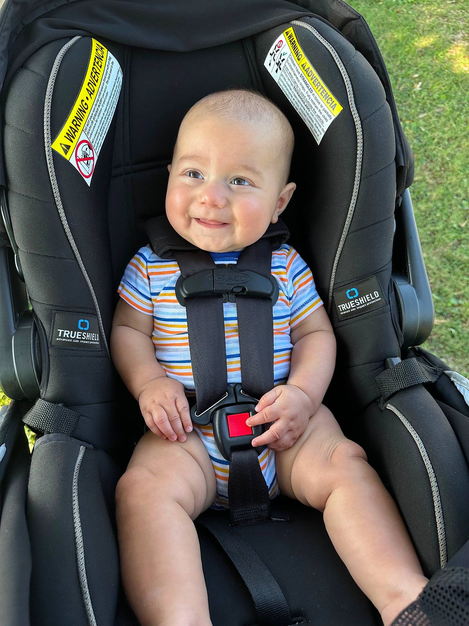 Miles is registered to the contest to win money with this photo: auto_part, baby, baby_carriage, baby_products, black, blue, car_seat, child, comfort, electric_blue, joy, leisure, person, personal_protective_equipment, product, recreation, sitting, sleeve, smile, thigh
