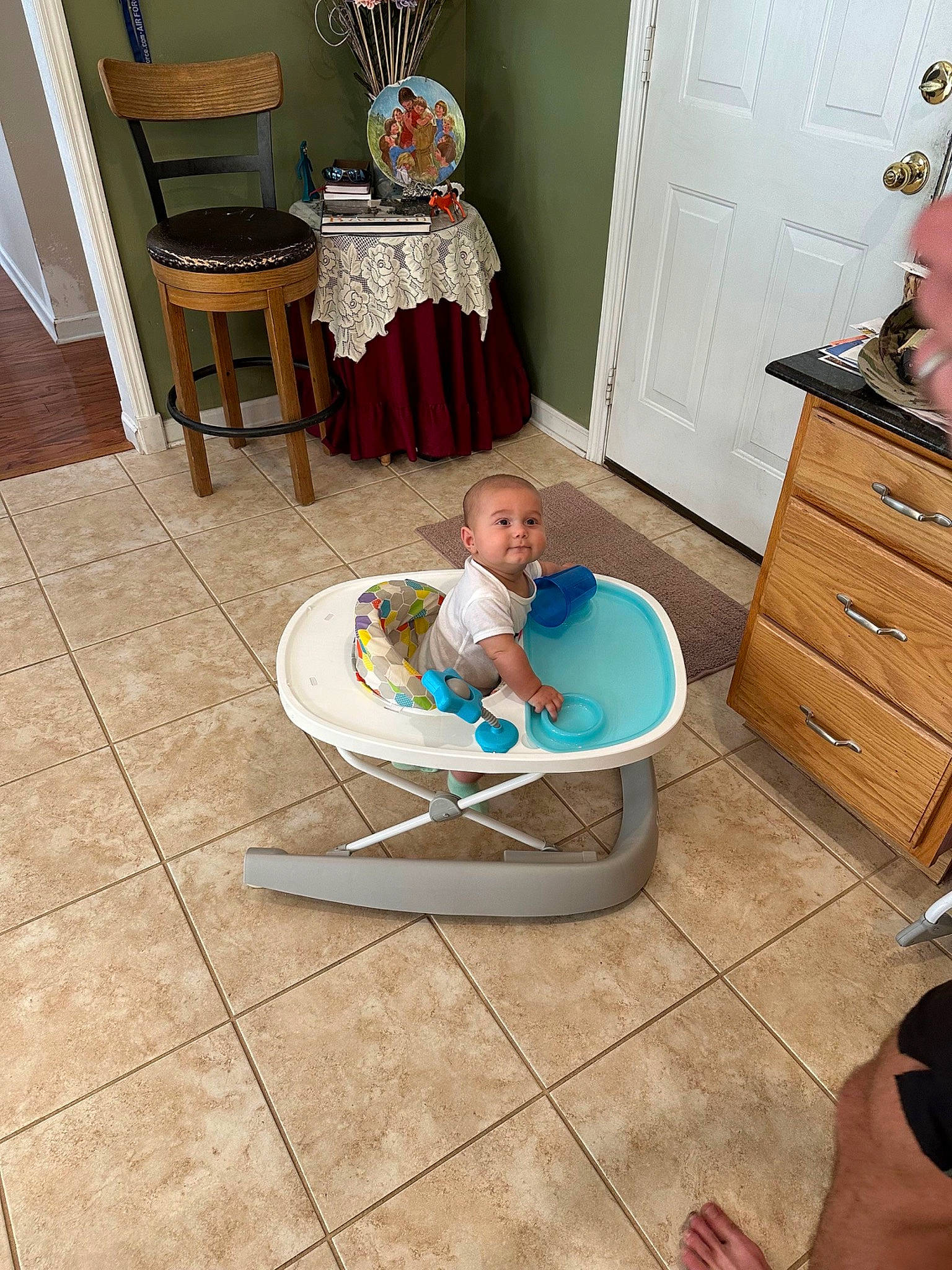 Miles is registered to the contest to win money with this photo: baby, cabinetry, chair, chest_of_drawers, comfort, door, drawer, dresser, floor, flooring, furniture, hardwood, house, leisure, living_room, person, room, sitting, table, toddler