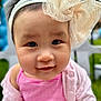 Mya joined the competition — help win amazing prizes! baby, child, face, headband, bow, pink_clothing, smile, outdoor, portrait, closeup, cute, infant, young_child, apparel, headwear, soft_focus, happy, skin, person, background_blur