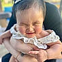 Mya joined the competition — help win amazing prizes! baby, child, infant, smiling, face, hair_accessory, white_clothing, cute, chubby_cheeks, person, adult_hands, holding, outdoor, blurred_background, portrait, happy, closeup, skin, expression, family