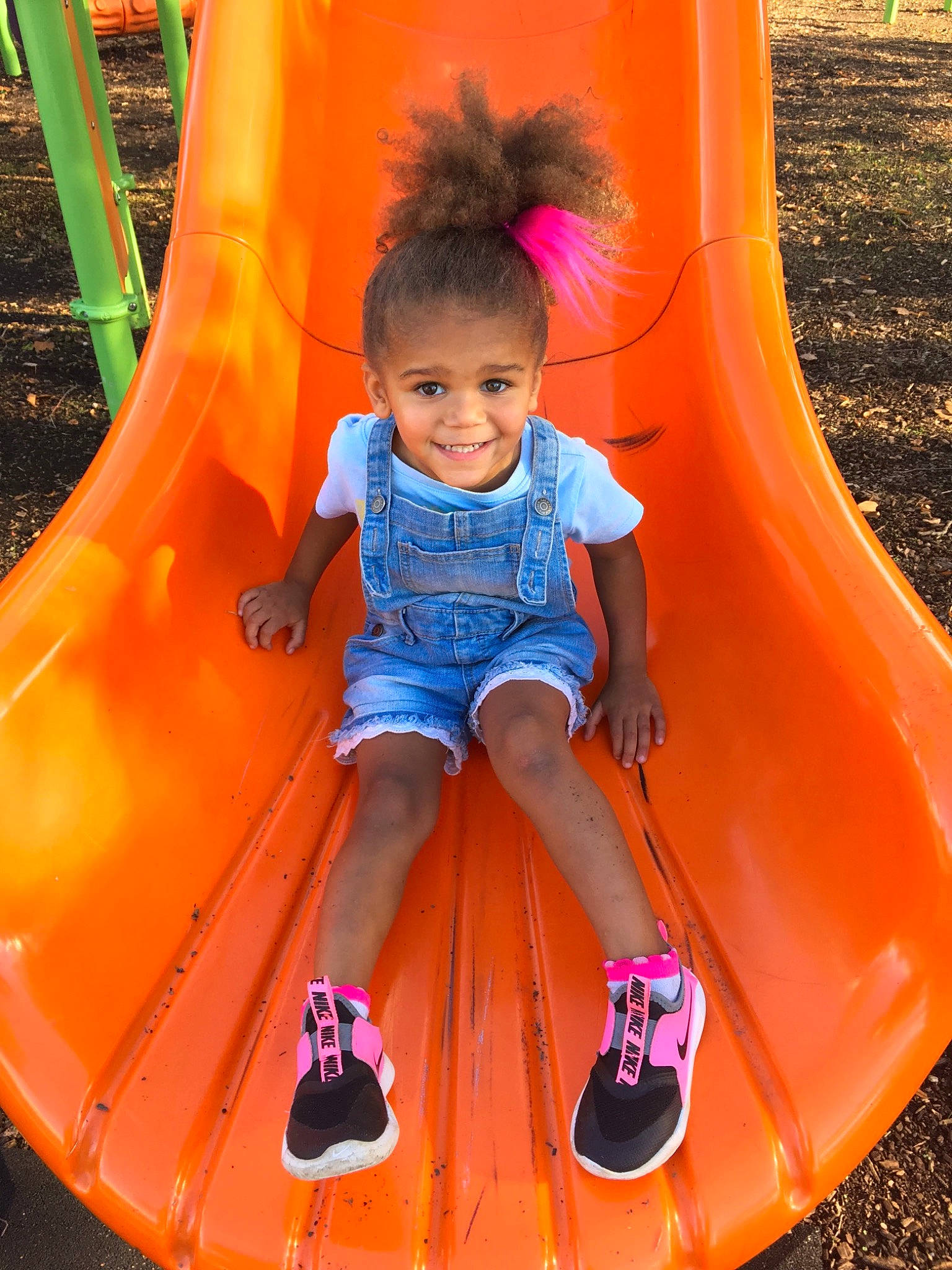 Tenaya joined the competition — help win amazing prizes! baby_toddler_clothing, chute, face, green, head, human_body, joy, leg, leisure, light, organ, person, photograph, pink, plant, playground, recreation, red, shoe, smile