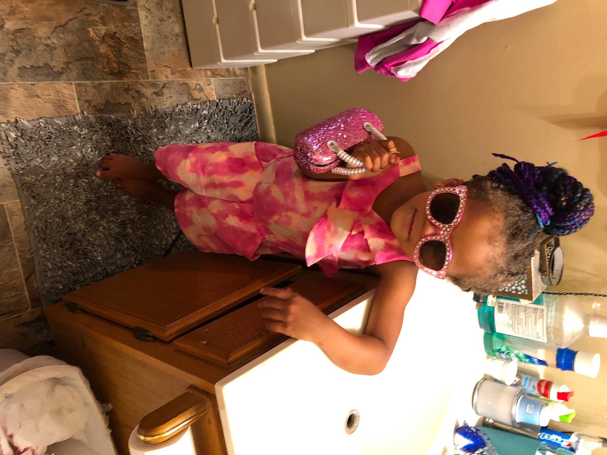 Tenaya is registered to the contest to win money with this photo: child, comfort, eyewear, fashion_design, flooring, fun, happy, house, human_leg, interior_design, leisure, magenta, person, personal_protective_equipment, pink, purple, room, sunglasses, t_shirt, textile