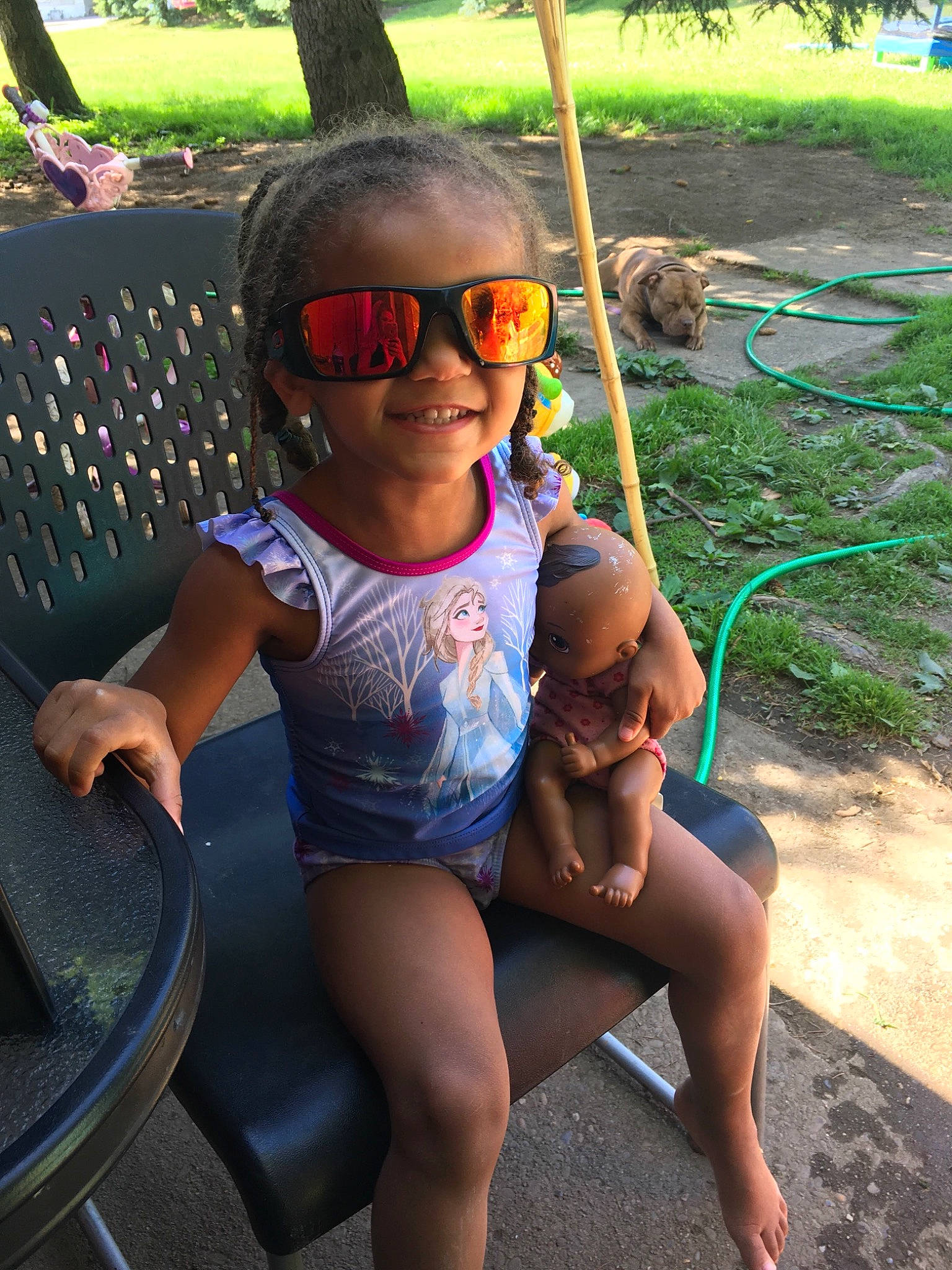 Tenaya is registered to the contest to win money with this photo: baby_toddler_clothing, barefoot, eyewear, finger, fun, goggles, grass, hairstyle, happy, joy, leg, leisure, mammal, morning, one_piece_swimsuit, person, public_space, smile, sunglasses, thigh