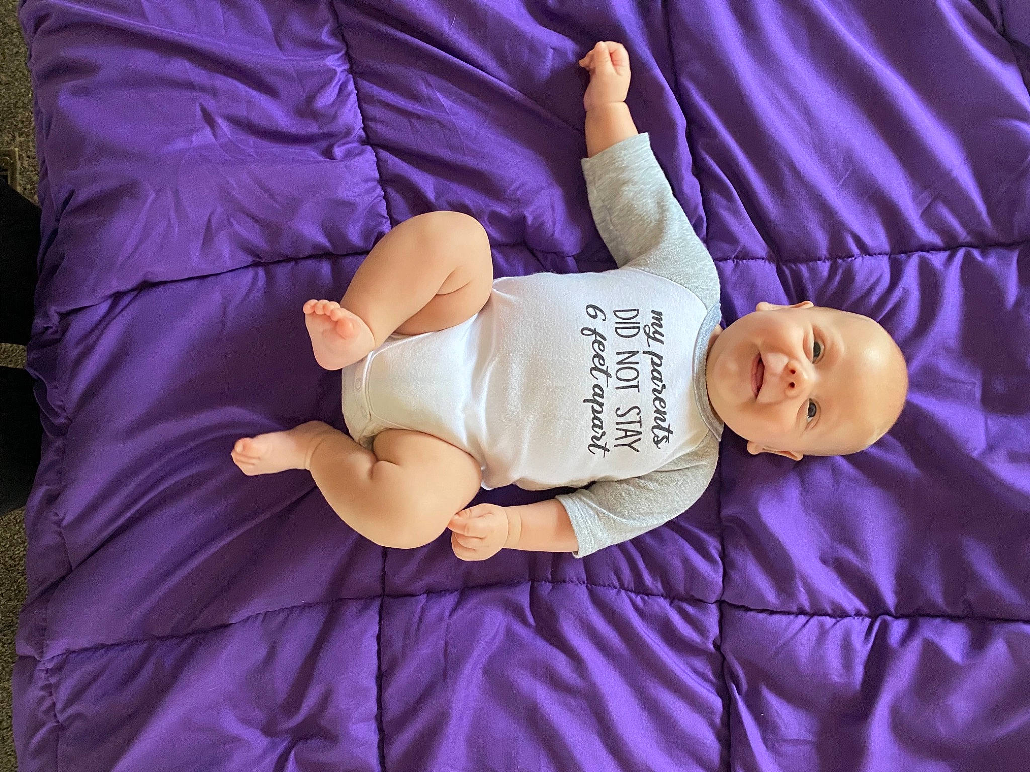 Opie is registered to the contest to win money with this photo: abdomen, arm, baby, baby_sleeping, baby_toddler_clothing, comfort, finger, glasses, hand, human_body, human_leg, knee, leg, linens, person, pink, purple, textile, thigh, trunk