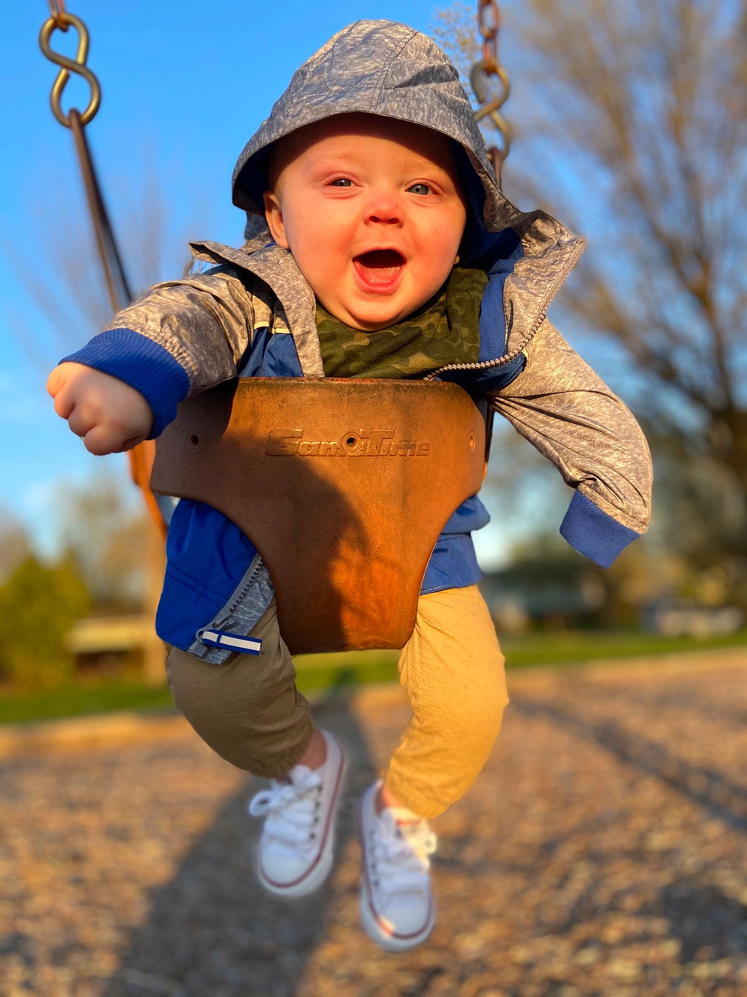 Korbin joined the competition — help win amazing prizes! child, eye, face, fun, grass, happy, hat, headgear, headwear, jacket, leisure, people_in_nature, person, recreation, sky, smile, sneakers, sun_hat, swing, toddler