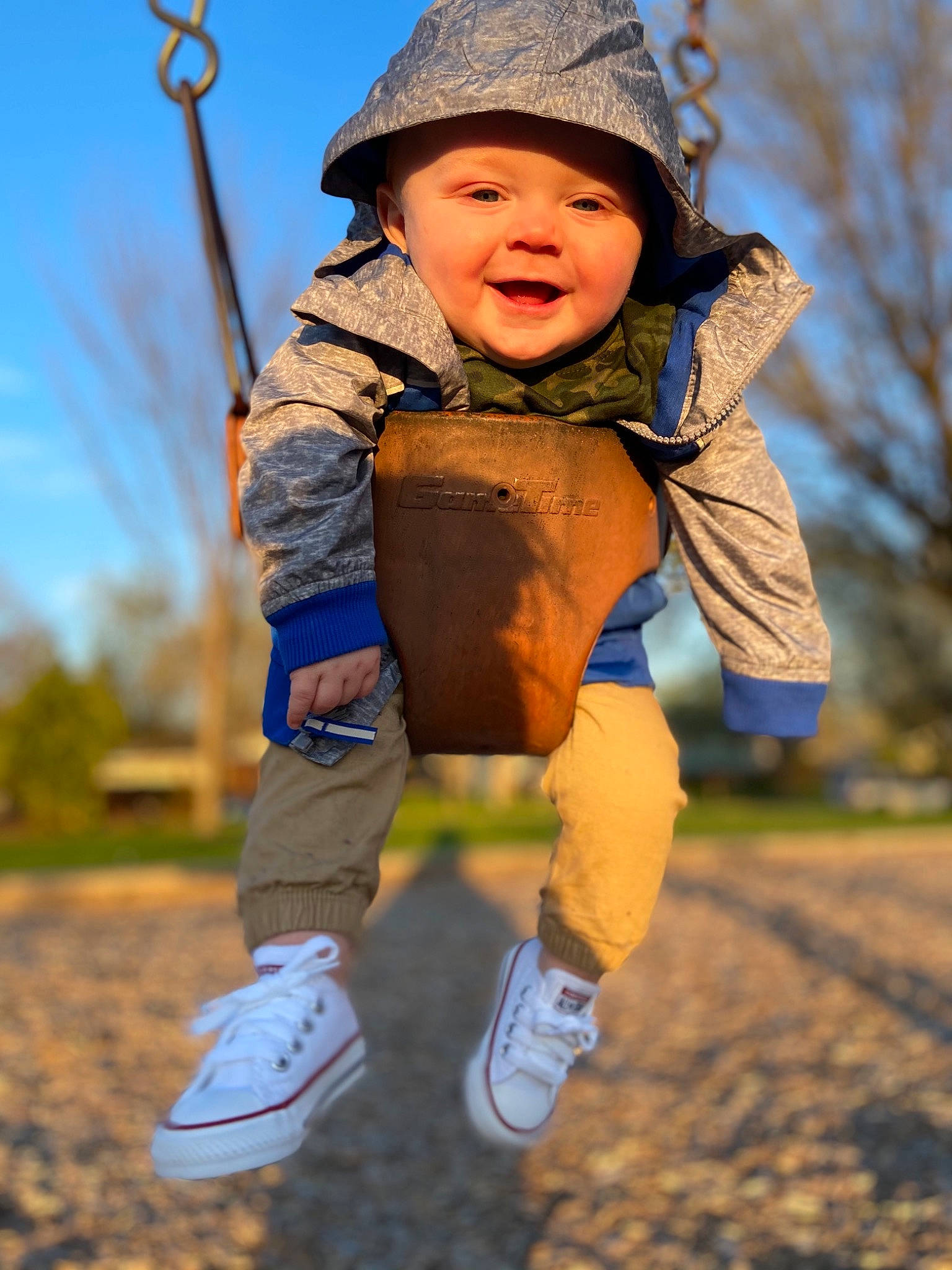 Korbin joined the competition — help win amazing prizes! baby, eye, facial_expression, flash_photography, gesture, grass, happy, headgear, headwear, leaf, leisure, people_in_nature, person, photograph, shoe, sky, smile, sneakers, swing, toddler