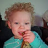 Arthur is registered to the contest to win money with this photo: toddler, child, curly_hair, blue_eyes, striped_clothing, onesie, blanket, crocheted_blanket, indoor, smiling, playing, hand, face, cute, young_child, baby, person, cozy, home, curly_hair_baby