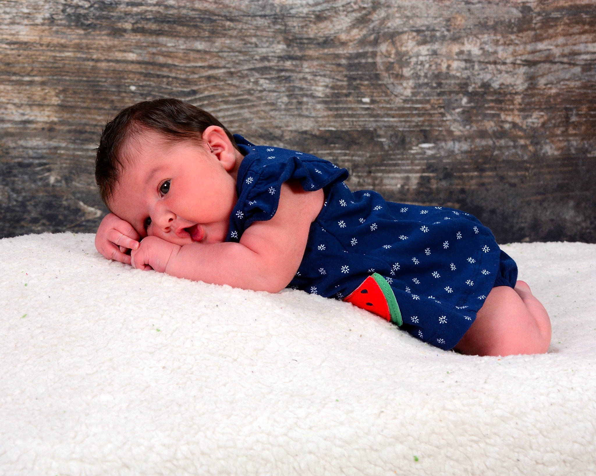 Ella is registered to the contest to win money with this photo: baby, baby_toddler_clothing, child, comfort, electric_blue, eye, fun, grass, head, human_body, landscape, leisure, pattern, people_in_nature, person, sand, sitting, snow, toddler, winter