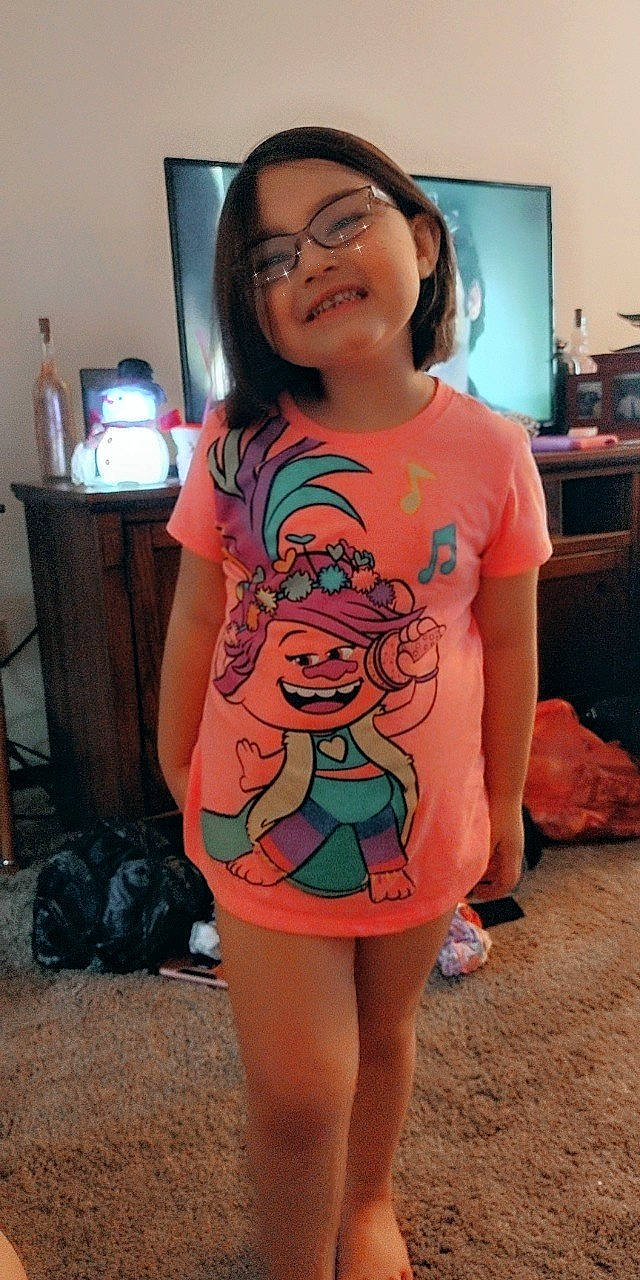 Anya joined the competition — help win amazing prizes! abdomen, black_hair, chest, cool, fun, hair, happy, head, human_body, human_leg, joy, mouth, neck, person, sleeve, smile, standing, t_shirt, television, thigh