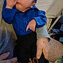 Kingston is registered to the contest to win money with this photo: baby, infant, child, person, blue_shirt, black_pants, moccasin_shoes, hand, candid, cute, indoor, seated, holding, cozy, casual_clothing, expression, small_child, newborn, portrait, human
