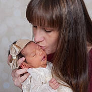 Sofia joined the competition — help win amazing prizes! newborn, baby, woman, kiss, face, headband, bow, sleeping, tender, love, affection, portrait, closeup, skin, long_hair, clothing, hand, indoor, soft_background, family