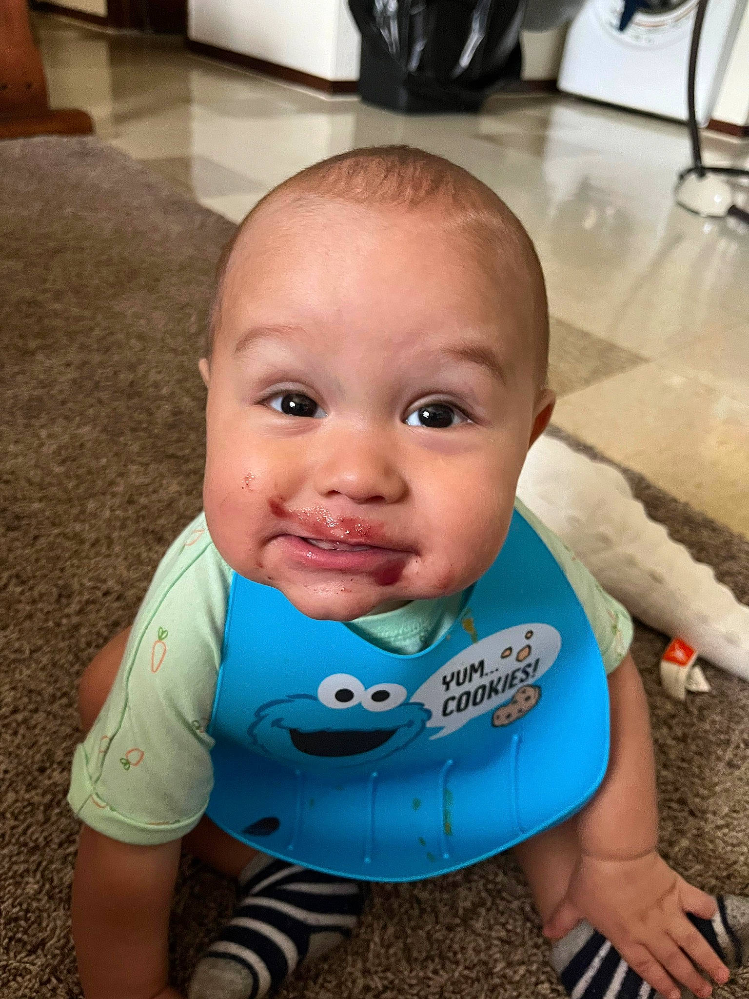 Andrius joined the competition — help win amazing prizes! baby, baby_toddler_clothing, bib, cheek, child, electric_blue, eye, eyebrow, eyelash, flooring, fun, happy, iris, nose, person, sitting, skin, sleeve, smile, t_shirt