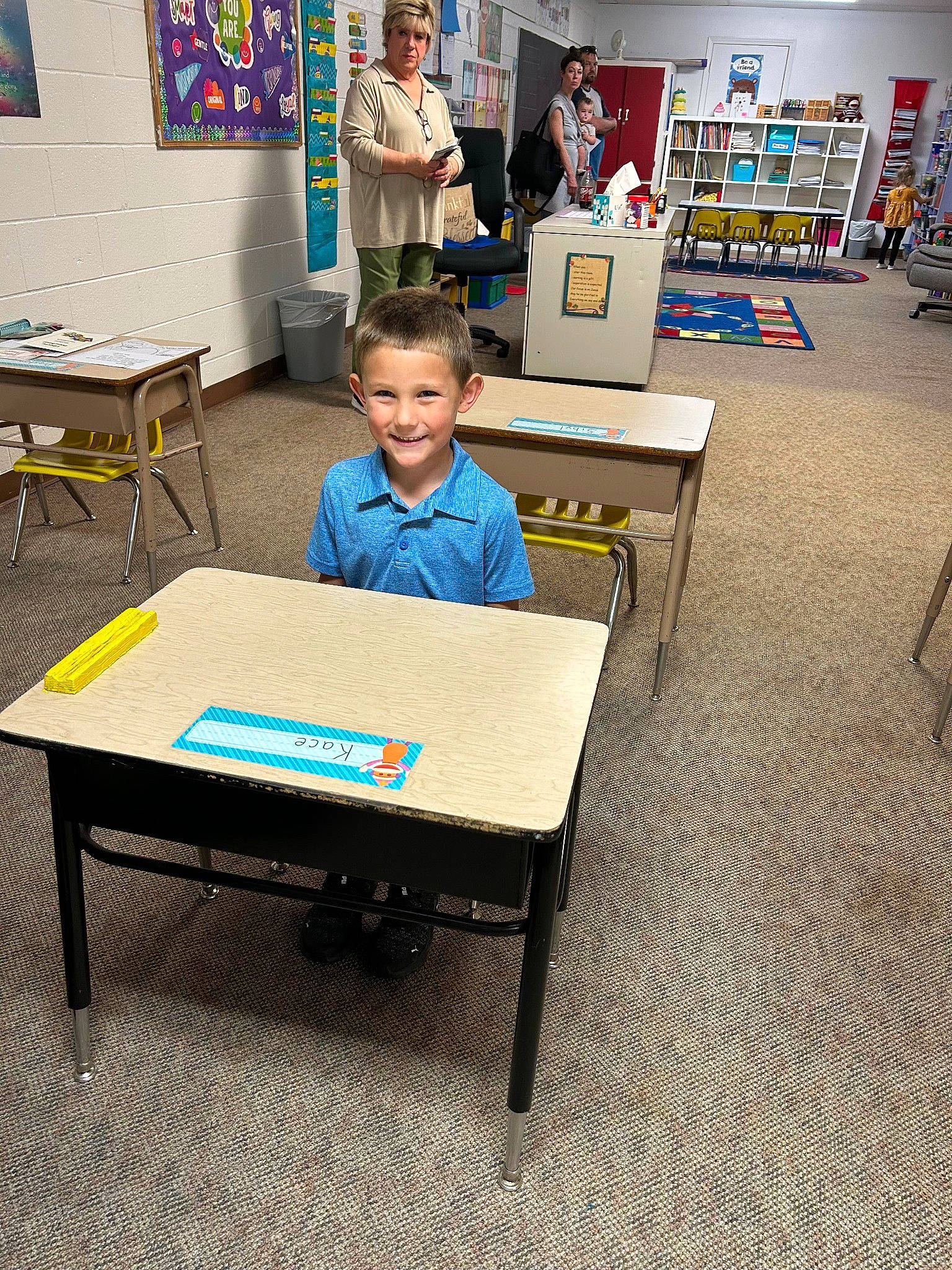 Kace joined the competition — help win amazing prizes! academic_institution, art, bookcase, chair, child, class, desk, engineering, event, flooring, furniture, indoor_games_and_sports, job, joy, leisure, person, recreation, room, sitting, smile