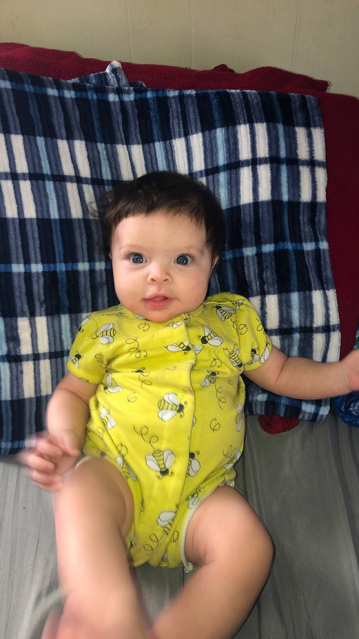 Paisley is registered to the contest to win money with this photo: arm, baby, baby_toddler_clothing, cheek, comfort, eye, face, facial_expression, hair, head, human_body, iris, leg, organ, person, skin, sleeve, tartan, textile, thigh